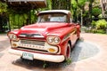 Red classic Chevrolet apache pickup truck for park decoration at `Ban Bang Khen` Royalty Free Stock Photo